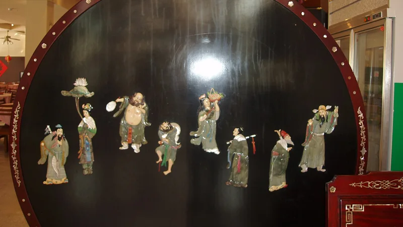 Eight Immortals decorations mounted on a circular dark display