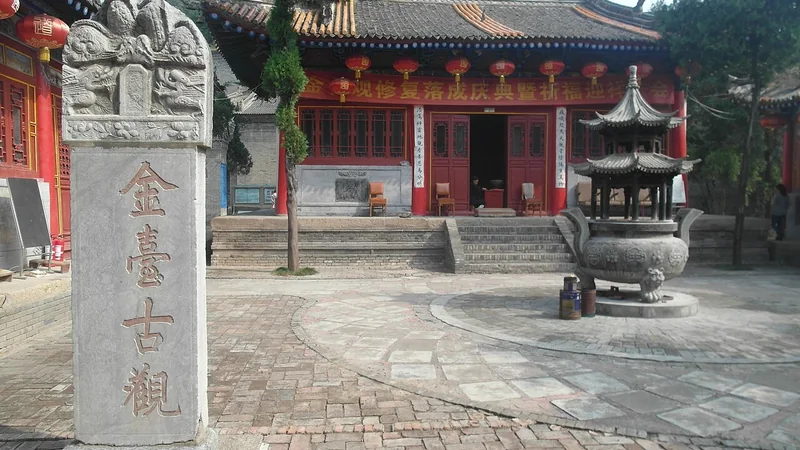 Traditional temple courtyard with stone stele and incense burner