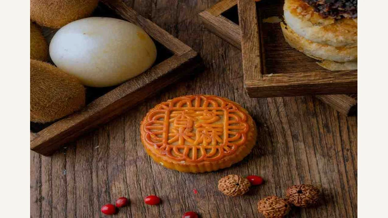 Mooncake and other food on a wooden table