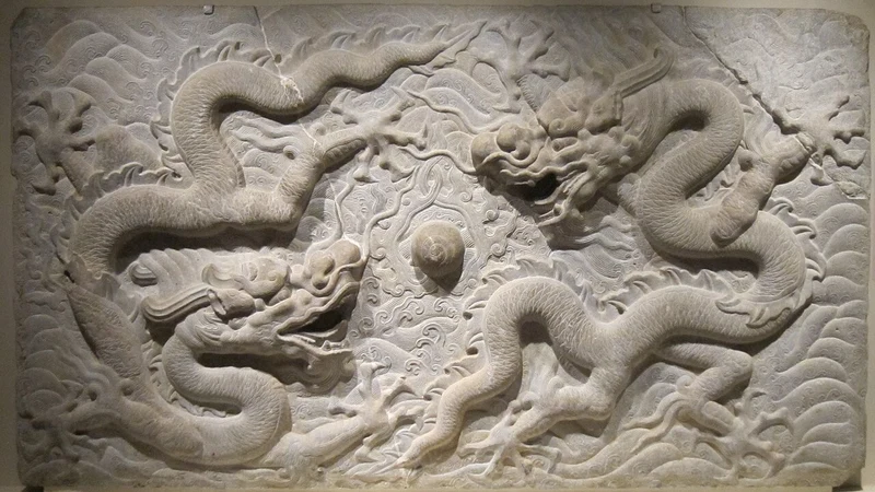 Stone relief with two dragons around a round motif